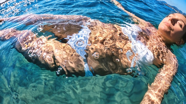 Free photo woman swimming in the water, mediterranean sea