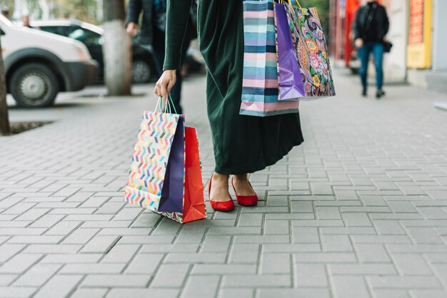 Woman taking bags on street 