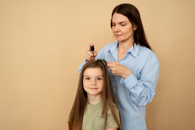 Woman taking care of girl medium shot