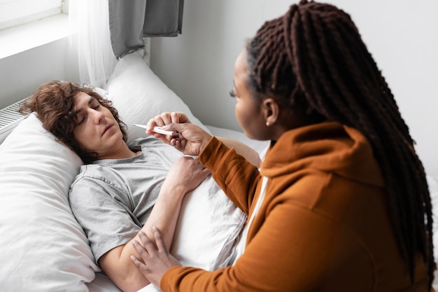 Woman taking care of her ill friend