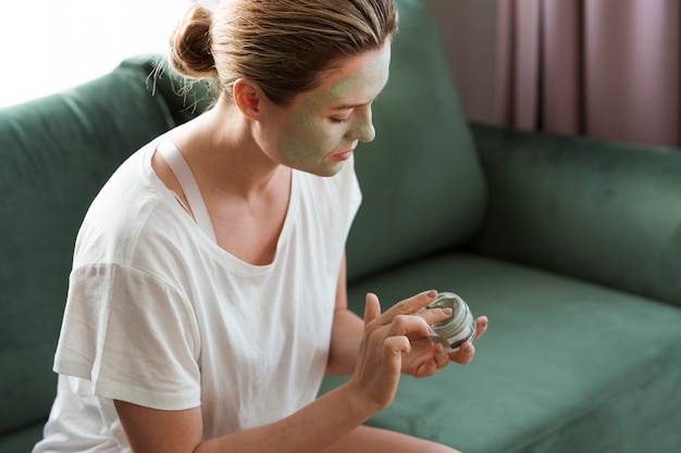 Free photo woman taking care of herself with facial mask