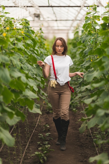 Woman taking care of plants in a greenhouse