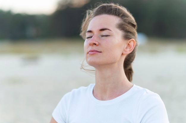 Woman taking in the fresh ocean breeze on the beach during workout