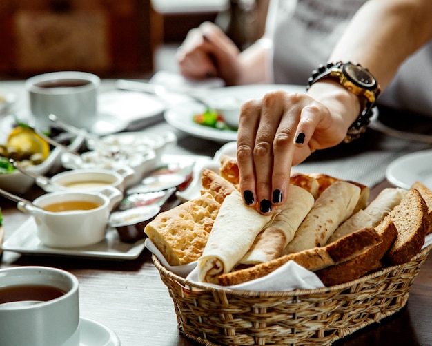 Free photo woman taking lavash from bread basket