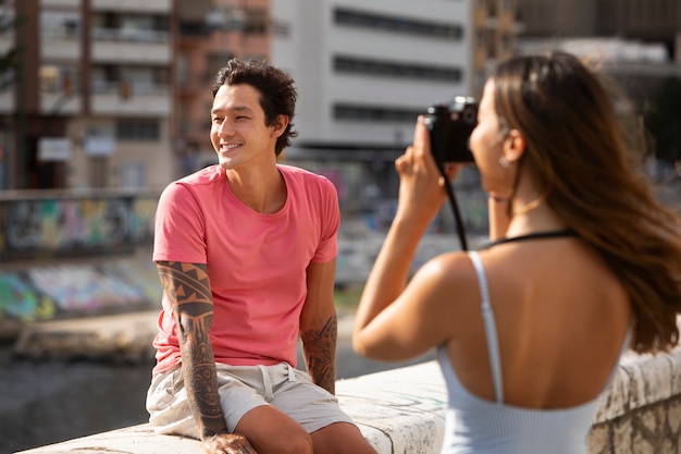 Woman taking a photo of her boyfriend