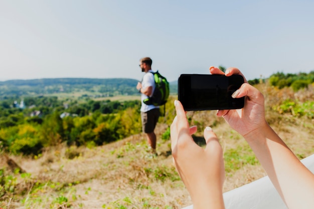 Woman taking a photo of his boyfriend