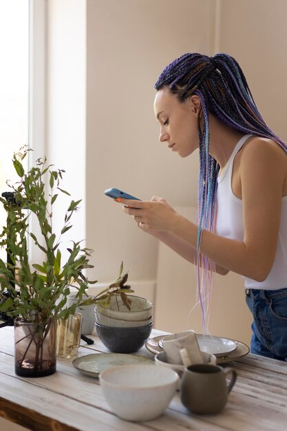 Woman taking photos of ceramic kitchenware