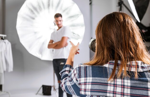 Woman taking photos of handsome model