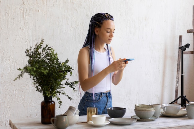 Woman taking photos for her business with kitchenware