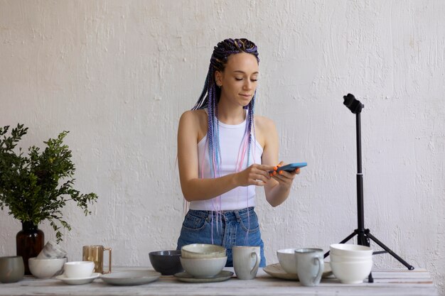 Woman taking photos for her business with kitchenware