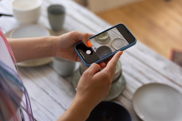 Woman taking photos for her business with kitchenware