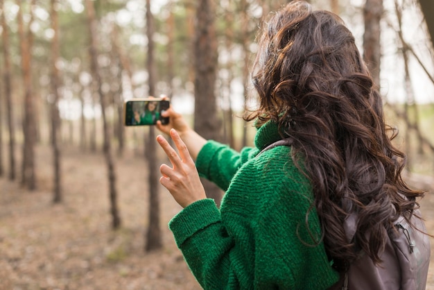 Free Photo woman taking photos of nature