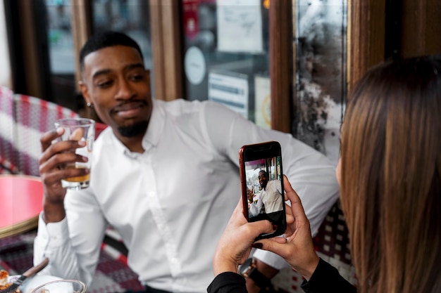 Woman taking photos of smiley man