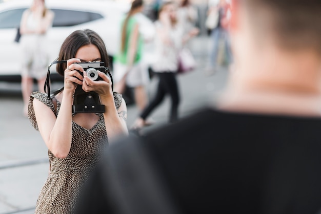 Free Photo woman taking picture of man