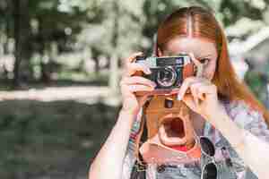 Free photo woman taking picture with camera