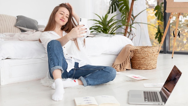 Woman taking a selfie at home