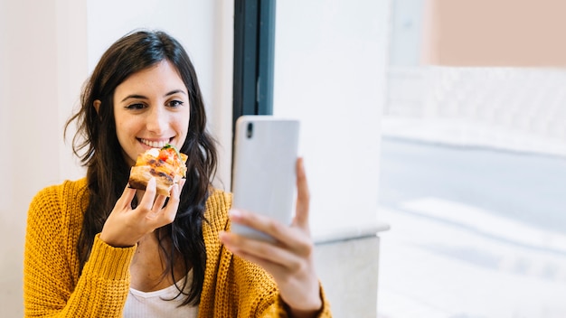 Woman taking selfie with food