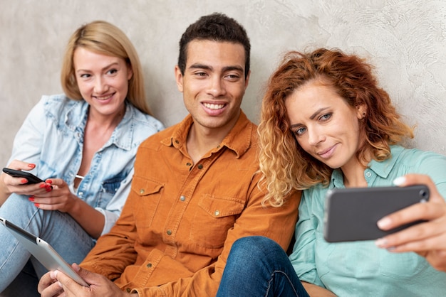 Woman taking a selfie with friends