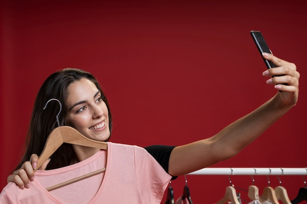 Woman taking a selfie with a pink t-shirt