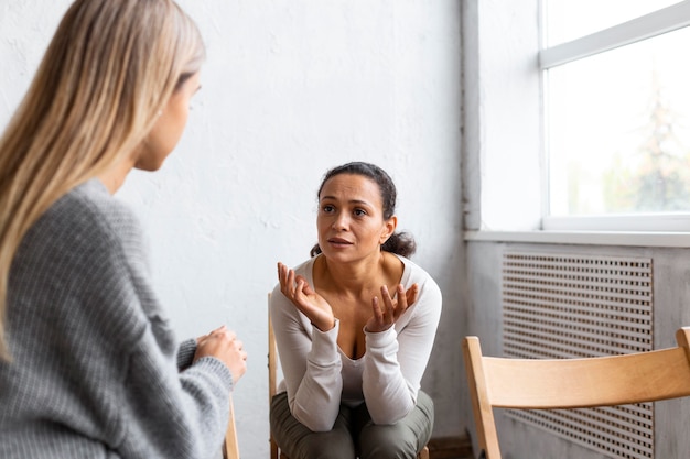 Woman talking about her problems at a group therapy session