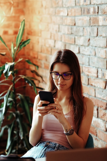 A woman talking to phone and chatting with friends