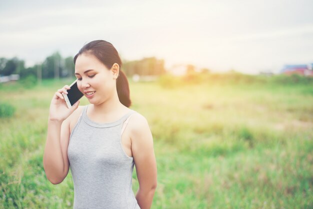 Woman talking on the phone in the field