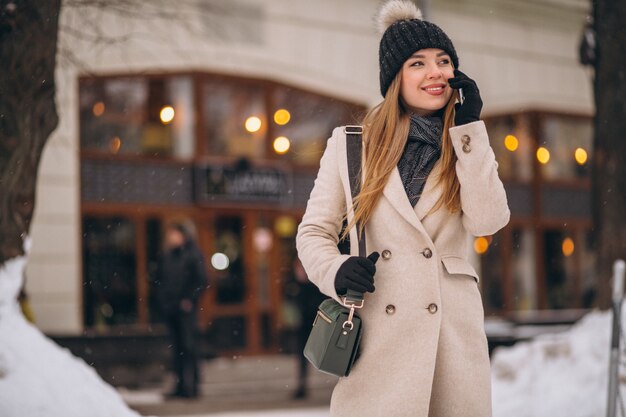 Woman talking on the phone outside the cafe 