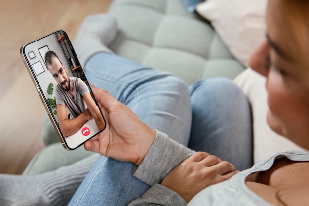 Free photo woman talking on video call with friend on phone