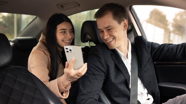 Woman talking with a taxi driver in the car