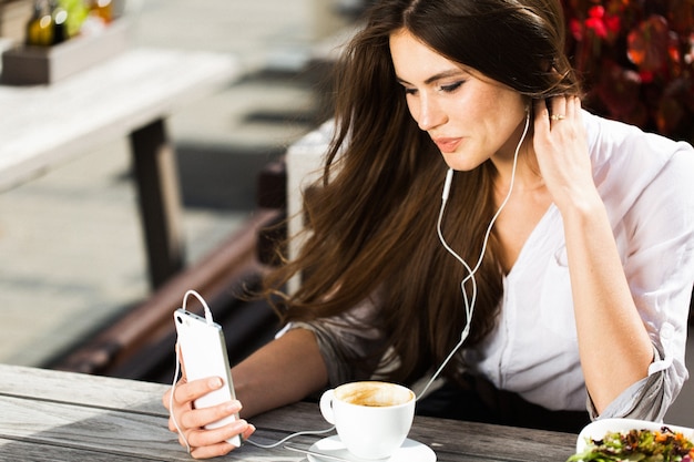 Woman talks via headphones on the phone