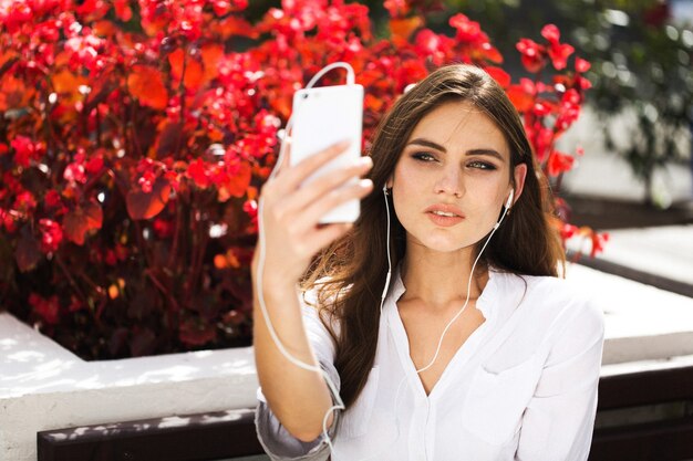 Woman talks via headphones on the phone