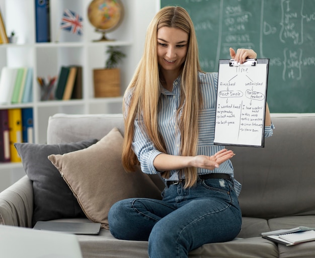 Woman teaching kids in english class online