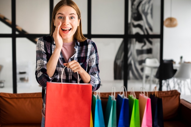 Woman telling a secret and holding a paper bag