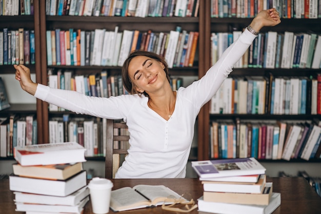 Free photo woman tired stretching at the library