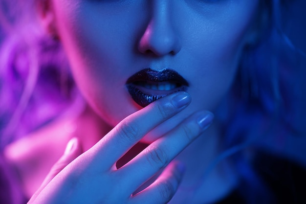 Free Photo woman touching bright lips