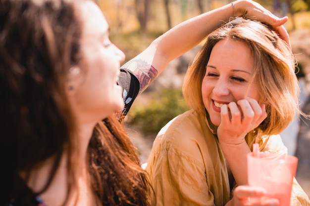 Woman touching hair of friend