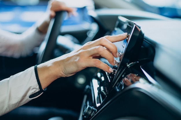 Free photo woman touching screen in her car