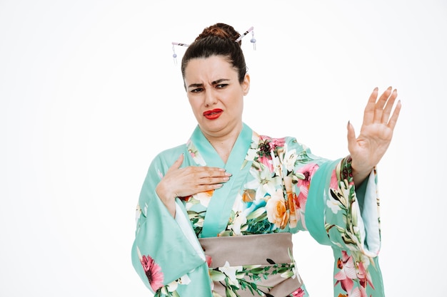 Free Photo woman in traditional japanese kimono looking with disgusted expression making stop gesture raising hands on white