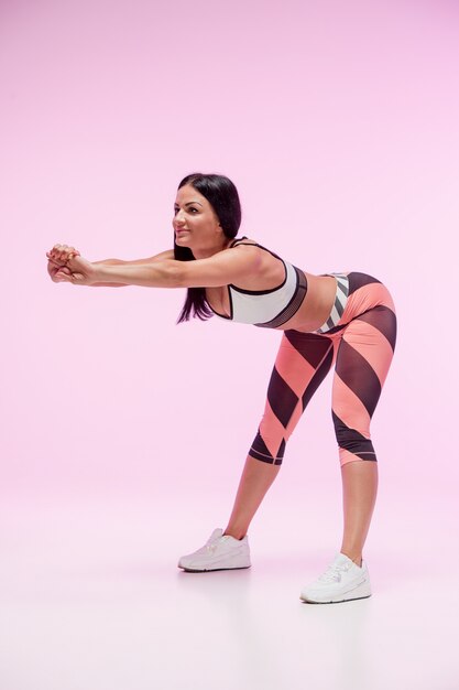 The woman training against pink