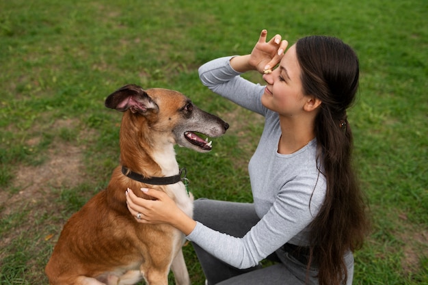 Free photo woman training dog  high angle