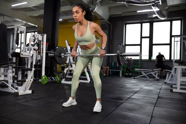 Woman training for weightlifting in gym