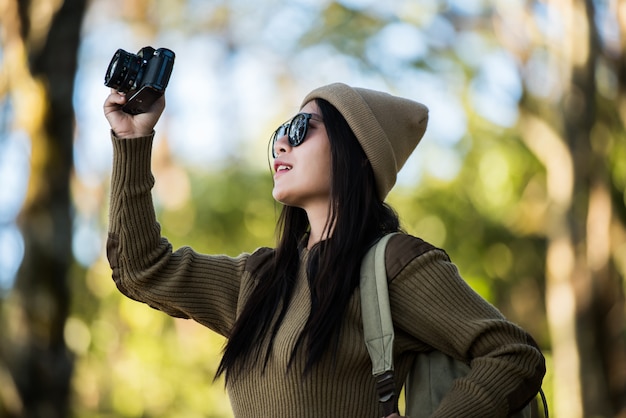 Free photo woman traveler going alone in the forest