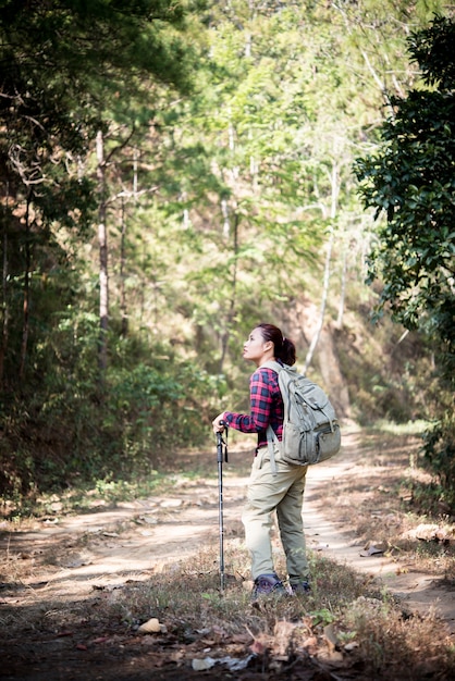 Woman traveler with backpack on beautiful summer landscape.