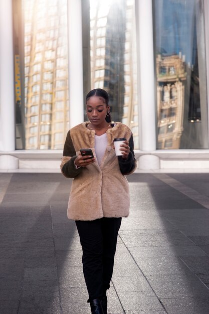 Woman traveling through city with her coffee