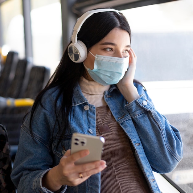 Woman traveling with mask and headphones