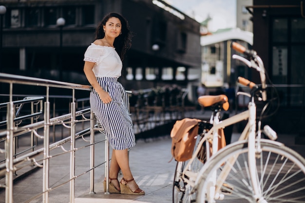 Woman travelling on bicycle in town