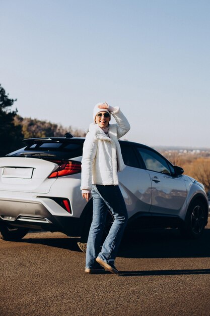 Woman travelling by car stopped by on the road