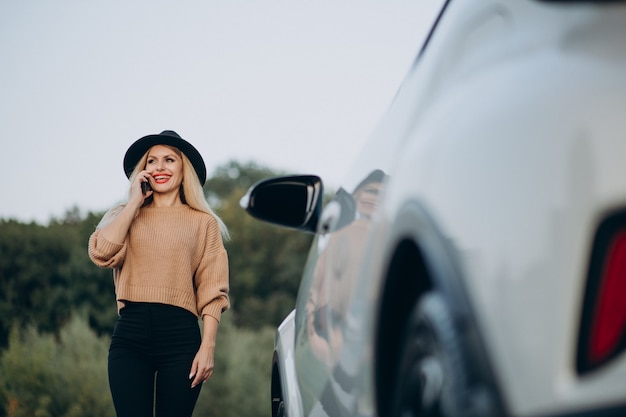 Woman travelling by car and using phone