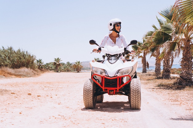 Woman travelling on quad by th ocean