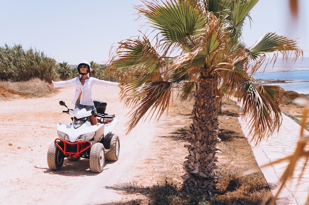 Woman travelling on quad by th ocean